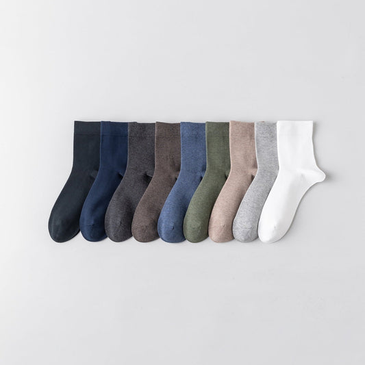 Set of eight pairs of socks in various colors on a light gray background